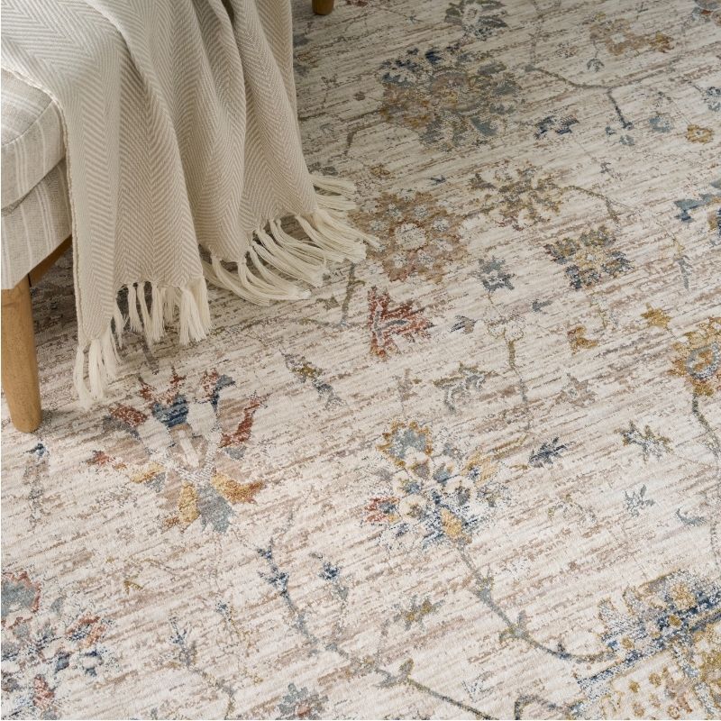 Patterned rug with a chair and blanket on a wooden floor