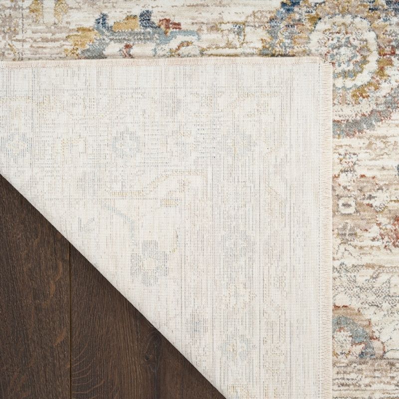 Close-up of a textured rug with a border on a wooden floor.