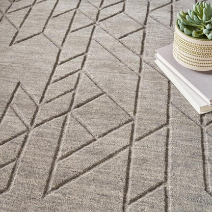 Gray geometric-patterned carpet with a plant and books on a table