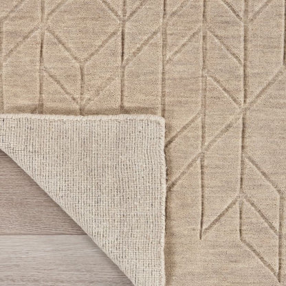 Beige textured rug with geometric pattern on a wooden floor