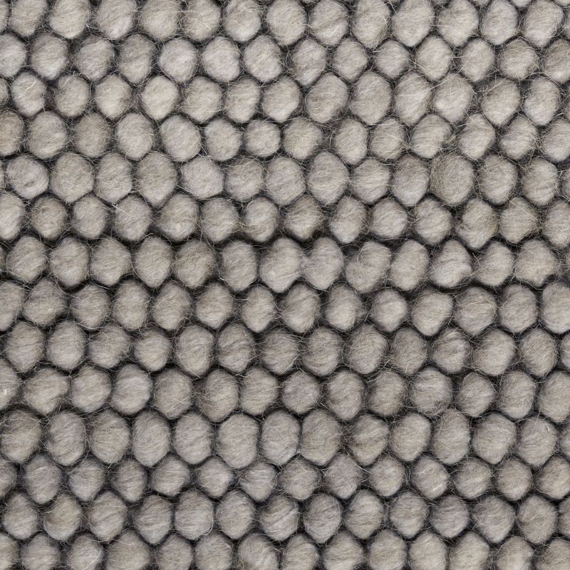 Close-up of a gray textured fabric with a repeating hexagonal or honeycomb-like raised pattern.