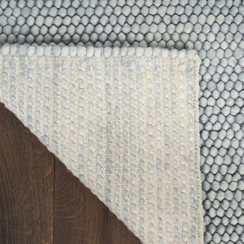 Close-up of textured rug with geometric pattern