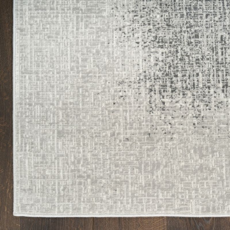 Textured gray rug on a wooden floor