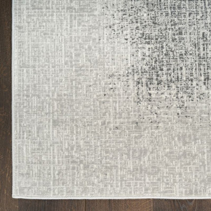 Textured gray rug on a wooden floor