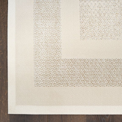 Close-up of a textured beige rug corner on a wooden floor
