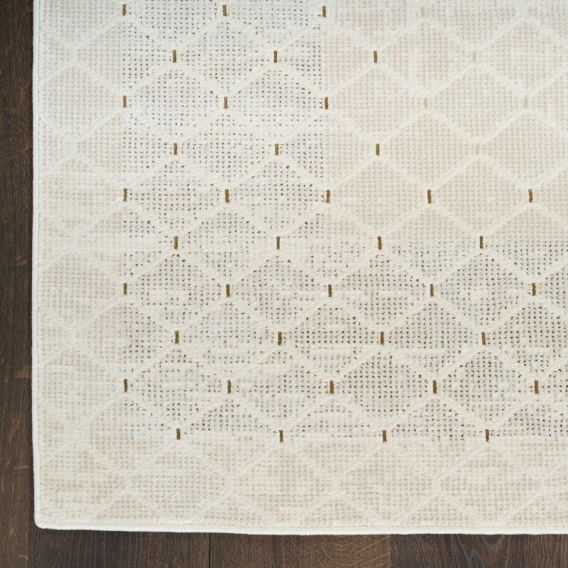 Textured white rug with a subtle pattern on a wooden floor