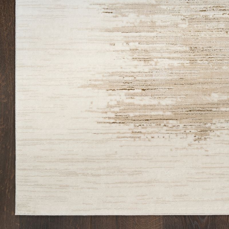 Close-up of a textured rug with a neutral color palette on a wooden floor.