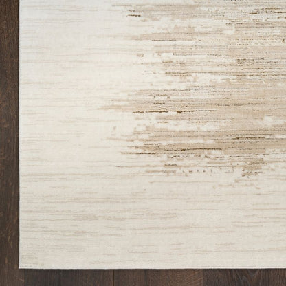 Close-up of a textured rug with a neutral color palette on a wooden floor.
