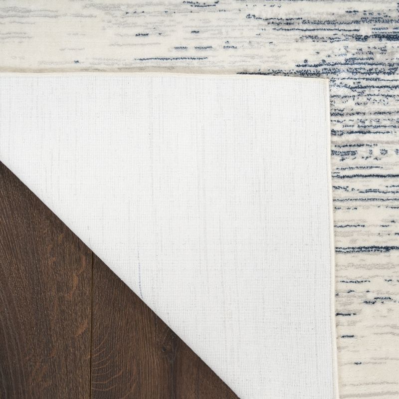 Close-up of a rug with a striped pattern on a wooden floor.