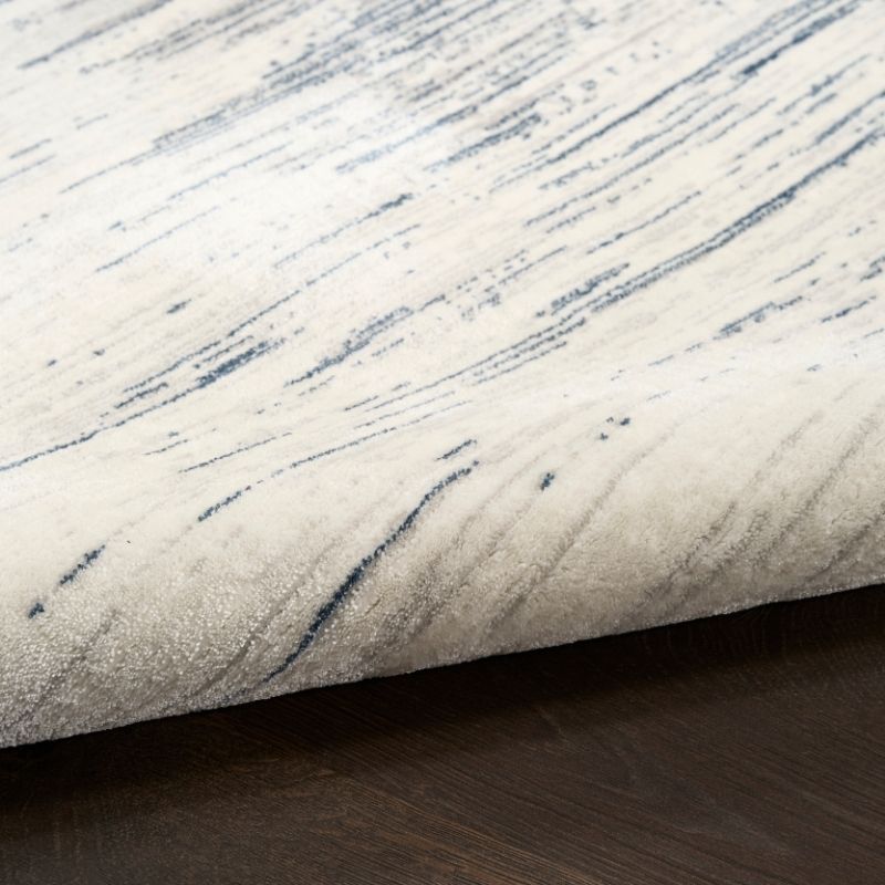 Textured fabric with blue streaks on a neutral background