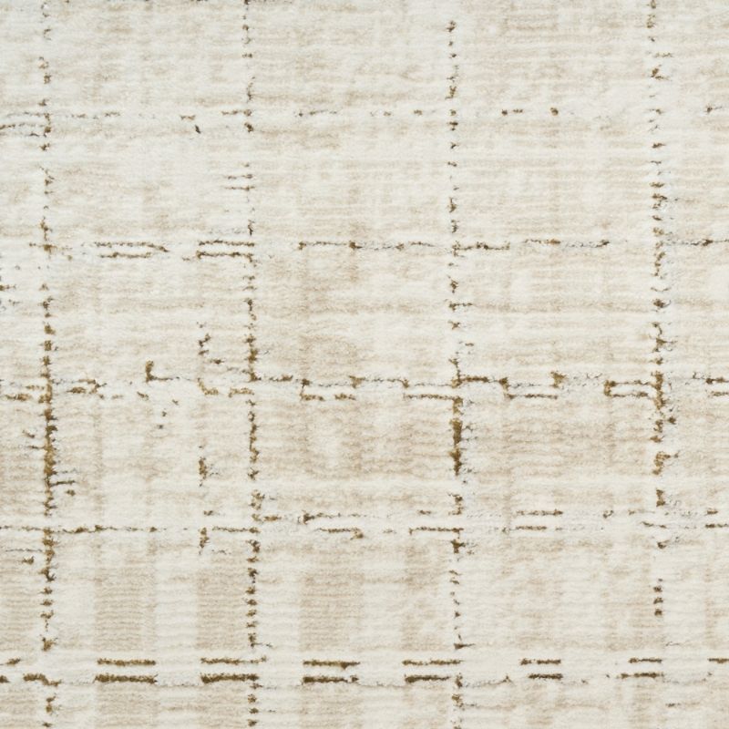 A close-up of a textured fabric or rug surface in warm off-white and beige with a faint distressed grid pattern.