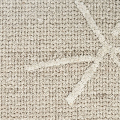 Close-up of a textured knit fabric in a warm beige or oatmeal tone, showing a subtle raised geometric star-like pattern.
