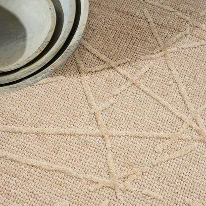 Close-up of a textured beige fabric surface with a woven pattern.