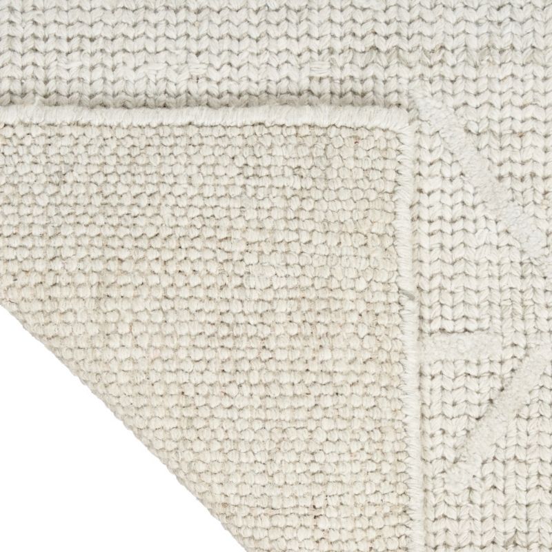Close-up of a textured beige rug with a subtle pattern