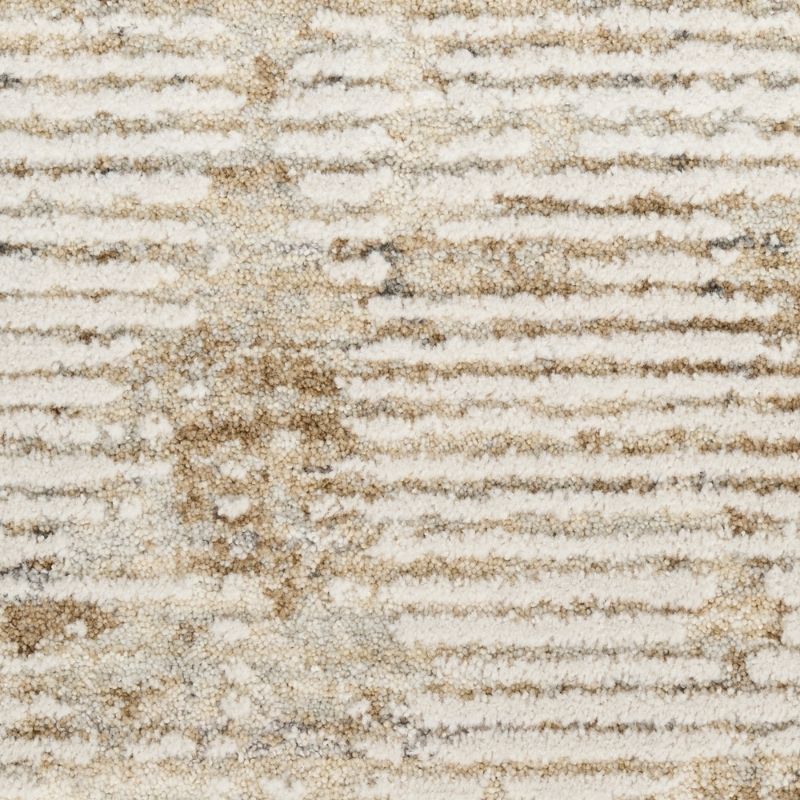 A close-up of a textured area rug with horizontal ribbed stripes in cream, beige, and light brown.