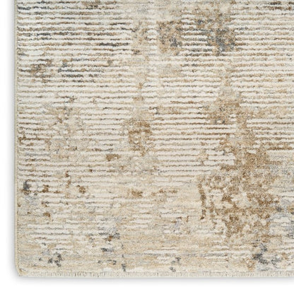 A close-up of a textured area rug with a distressed horizontal stripe pattern in cream, beige, and light gray tones.
