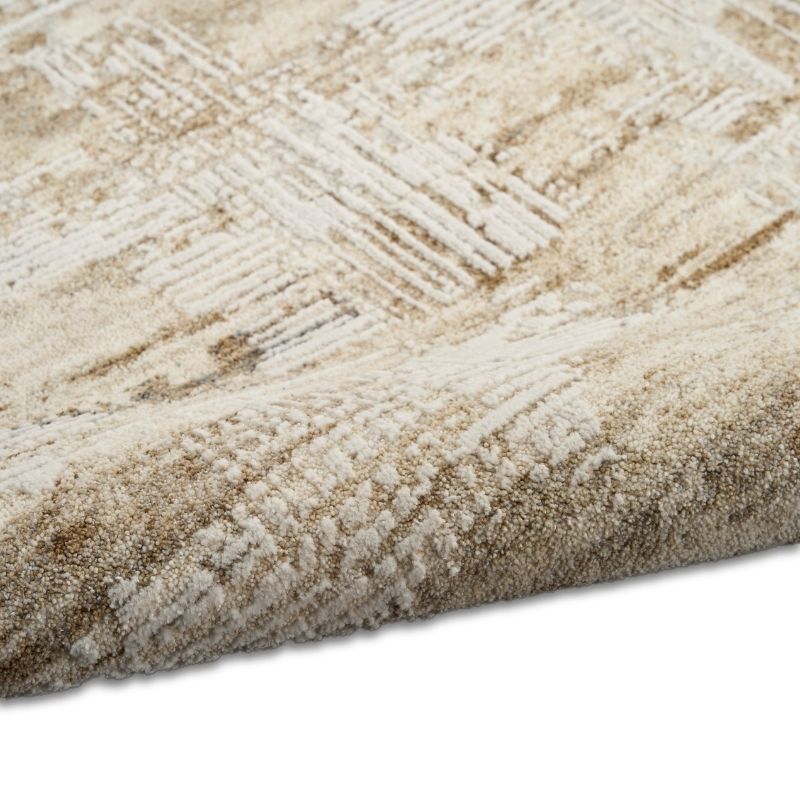 Close-up of a textured beige and brown rug with geometric pattern