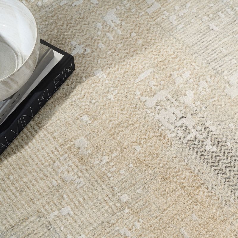 Close-up of a textured beige carpet with a book and bowl on top