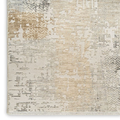 A close-up of a textured area rug with an abstract distressed pattern in cream, beige, light gray, and taupe tones.