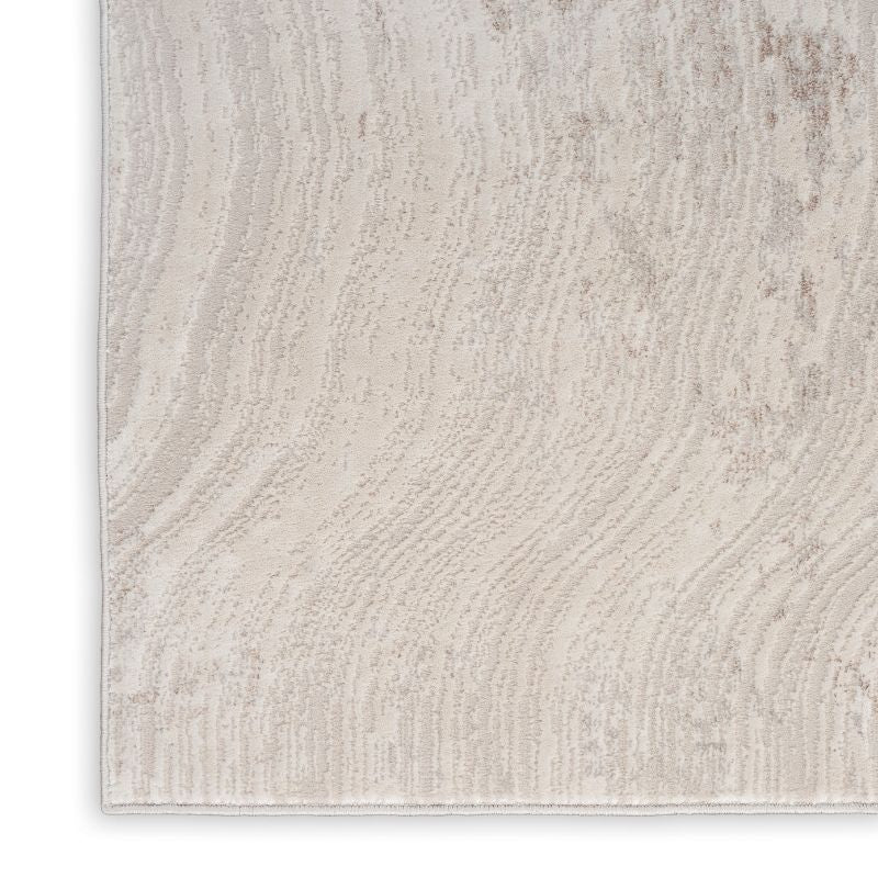 Textured beige rug with wavy pattern on a white background