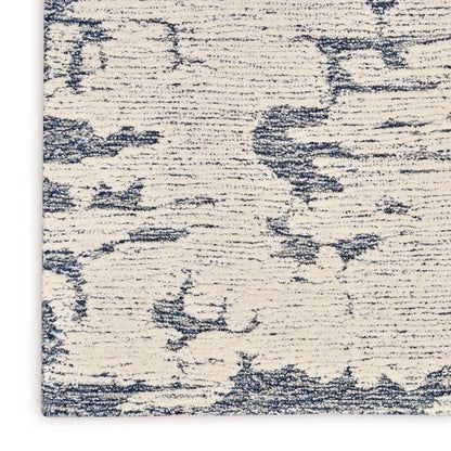 Textured rug with a blue and beige pattern