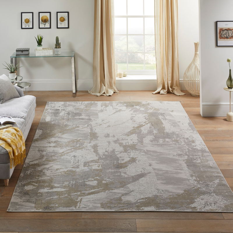 Living room with a large gray area rug, sofa, and decorative elements.