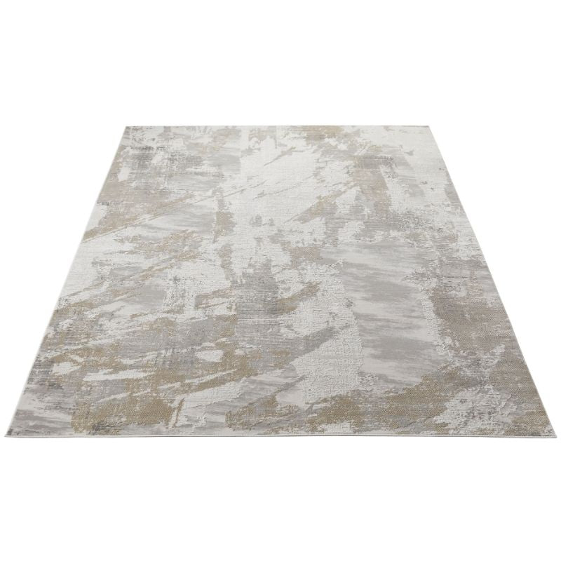 An abstract area rug with a distressed, painterly pattern in shades of beige, gray, and off-white, shown from a top-down perspective on a white background.