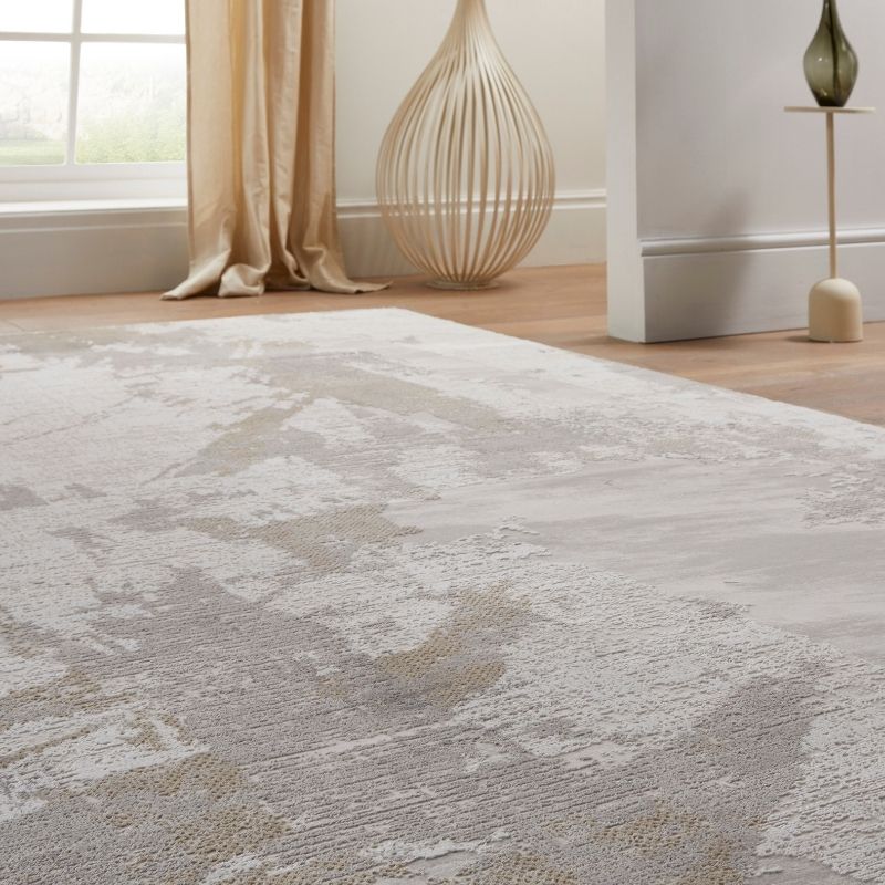 Textured area rug on a wooden floor with decorative elements in the background