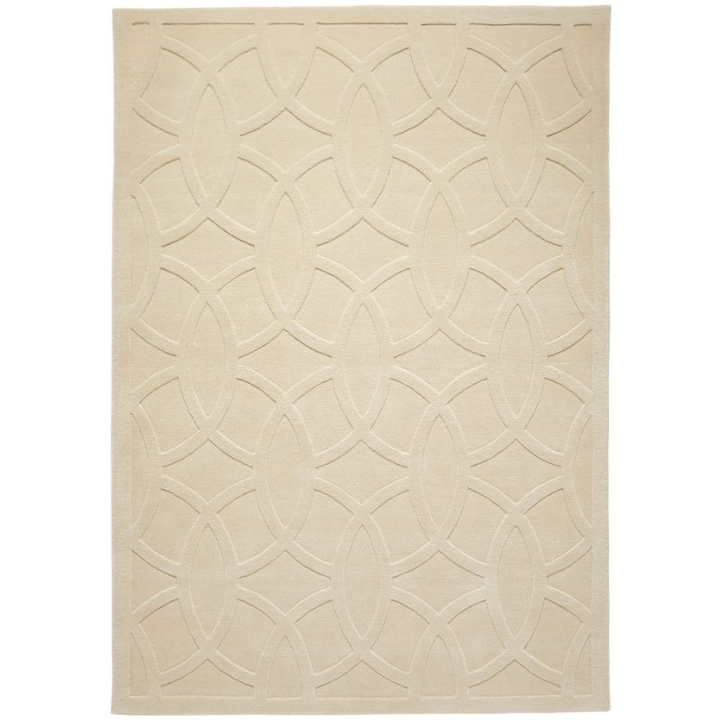 A rectangular area rug in a warm cream or beige color, featuring a raised geometric trellis pattern of interlocking ovals.