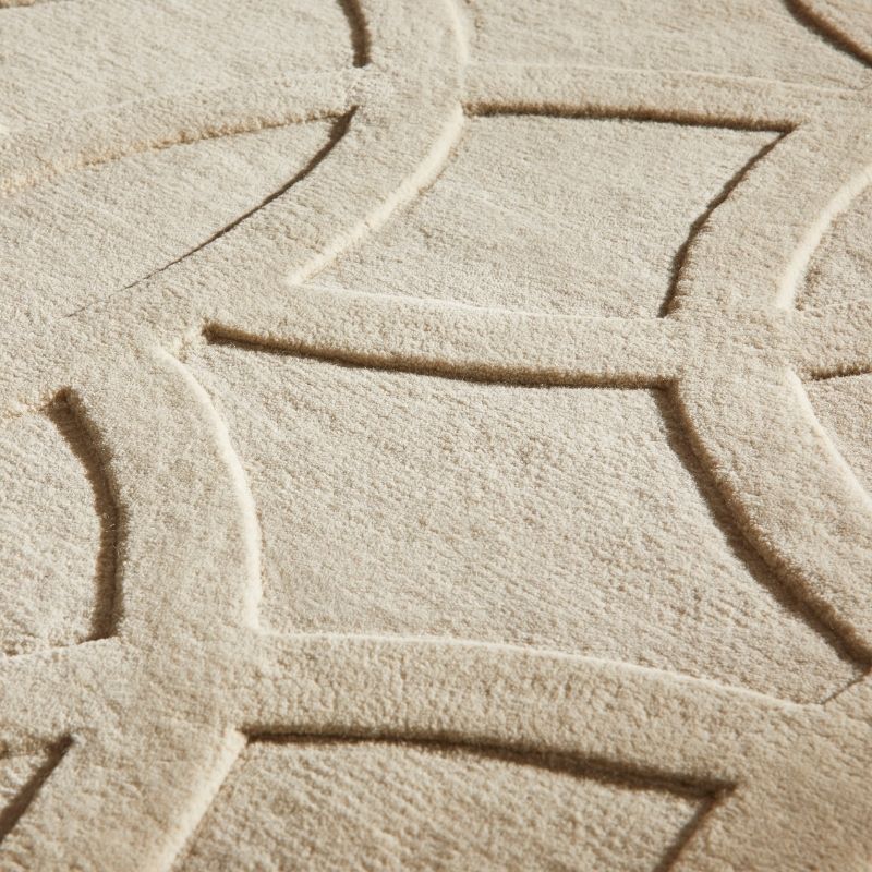 Close-up of a textured beige fabric with a geometric pattern