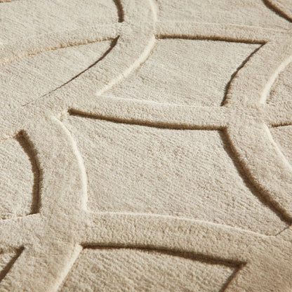 Close-up of a textured beige fabric with a geometric pattern