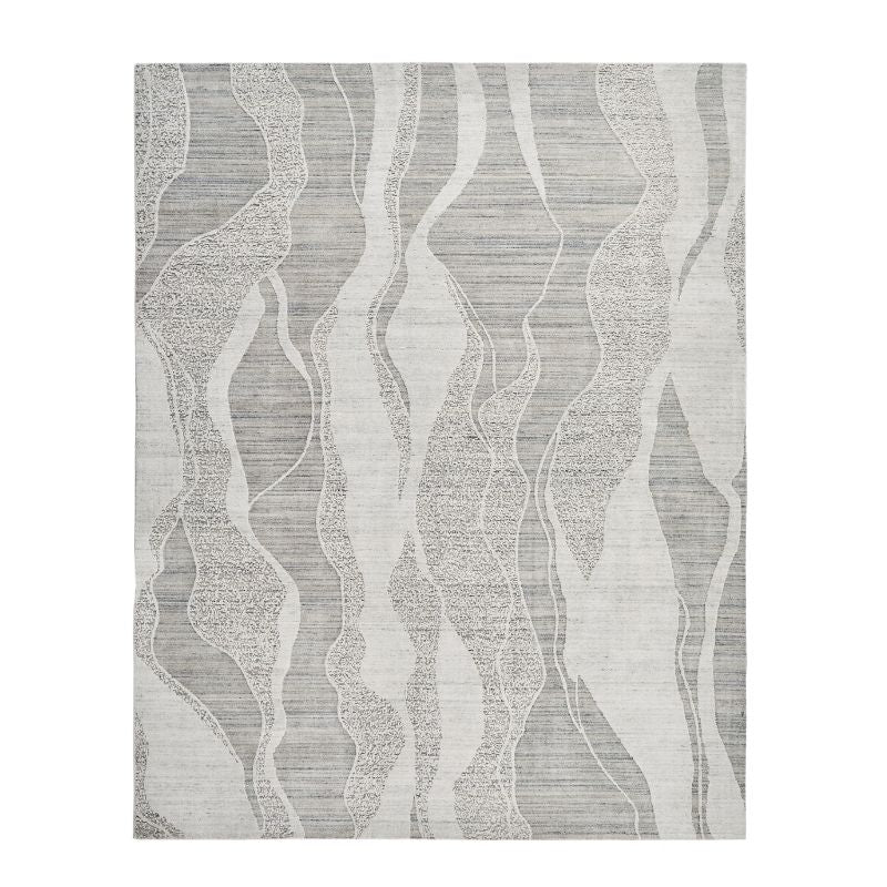 A square area rug with a modern abstract pattern of wavy vertical bands in light gray, medium gray, and off-white, showing a subtle woven texture.