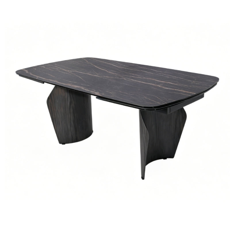A modern rectangular dining table with a dark wood grain top and sculptural dark wood legs, shown on a plain white background.
