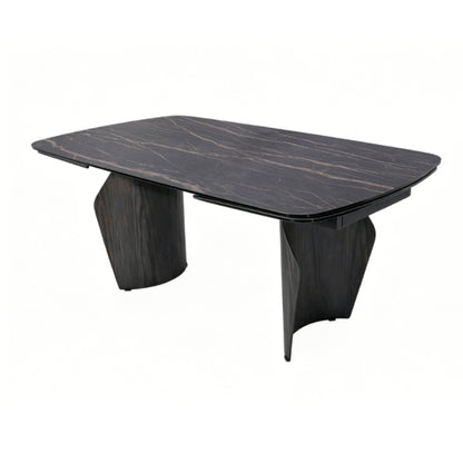 A modern rectangular dining table with a dark wood grain top and sculptural dark wood legs, shown on a plain white background.