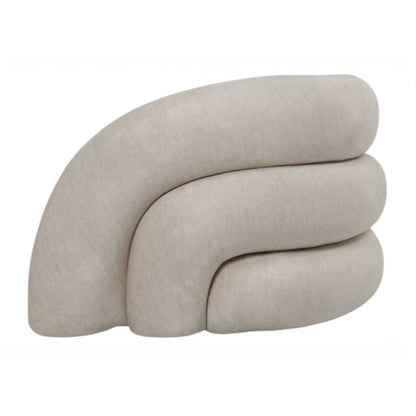 A modern curved upholstered ottoman or low stool in a light beige fabric, shown against a plain white background.