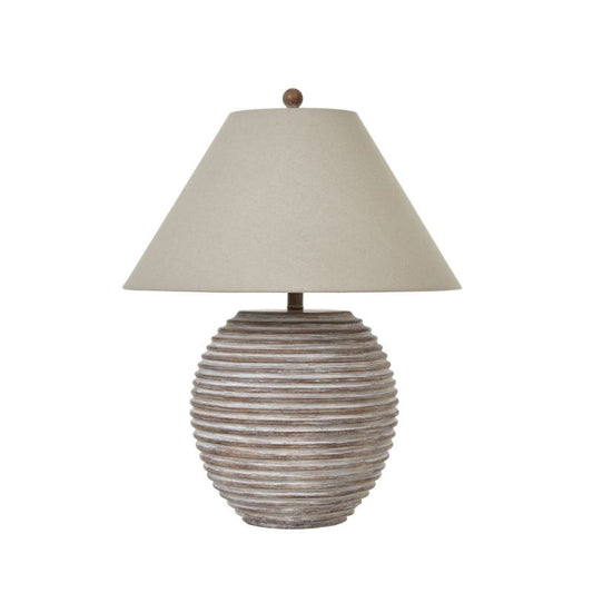 Table lamp with ribbed ceramic base and beige lampshade on a white background